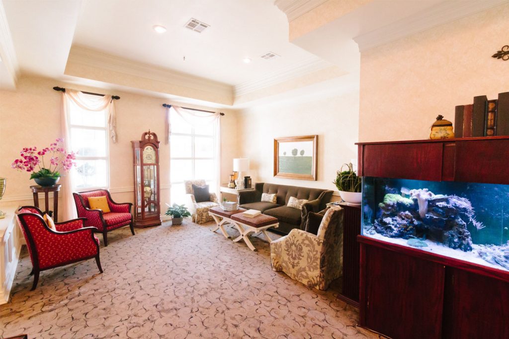 A common room with a fish tank at a respite care facility