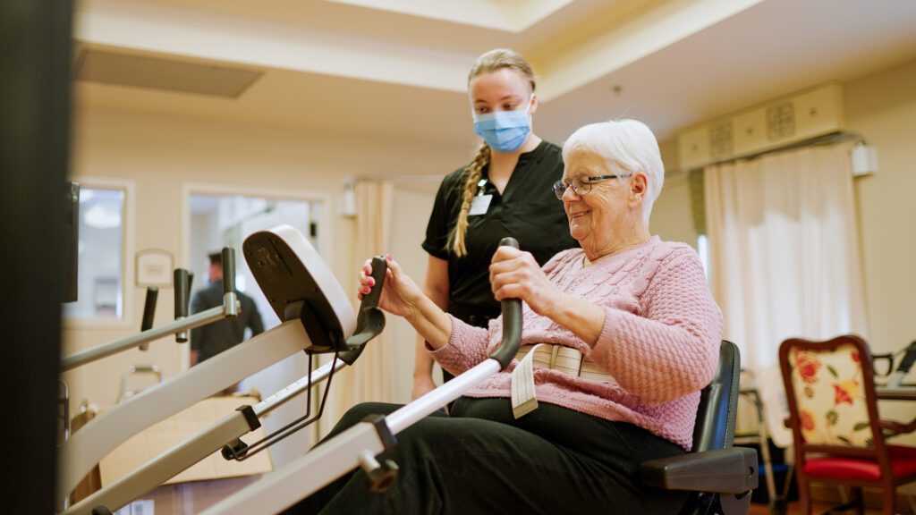 A woman on physical therapy equipment at a short term care center